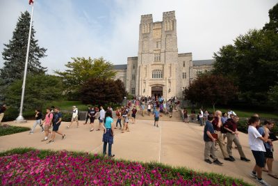 Students walking around outside of Burruss Hall.
